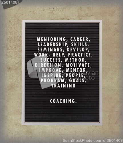 Image of Coaching concept in plastic letters on very old menu board