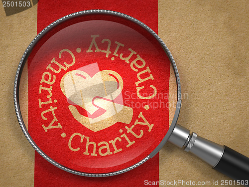 Image of Magnifying Glass with Charity Concept.