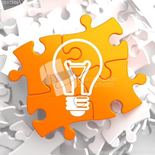 Image of Light Bulb Icon on Orange Puzzle.