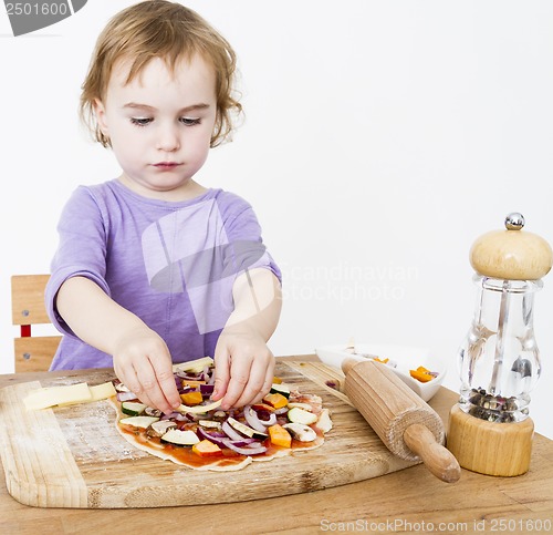 Image of little girl making fresh pizza