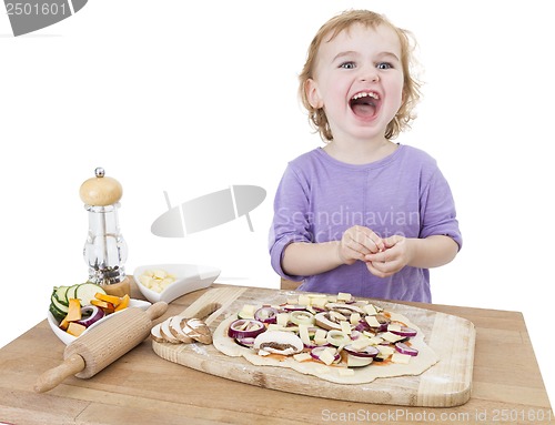 Image of laughing child with home made pizza