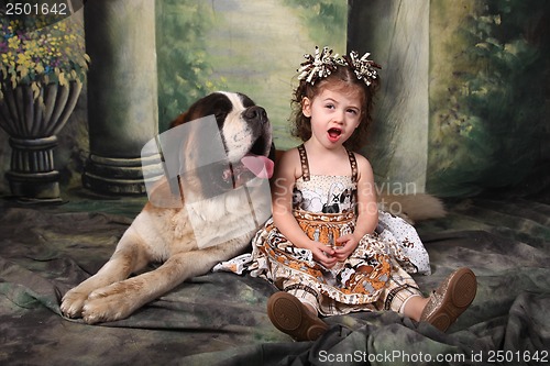 Image of Adorable Child and Her Saint Bernard Puppy Dog