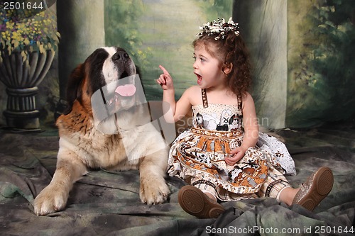 Image of Adorable Child and Her Saint Bernard Puppy Dog