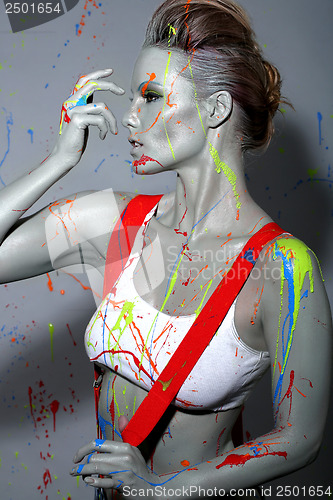 Image of Female House Painter Splattered with Latex Paint