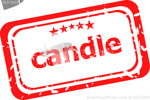 Image of candle on red rubber stamp over a white background