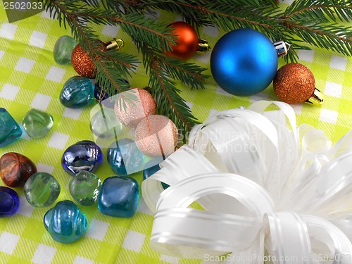 Image of Christmas decoration with stones flowers and christmas baubles