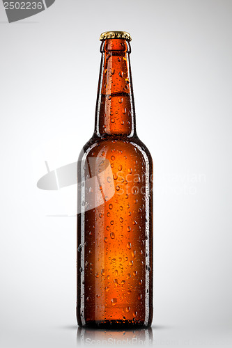 Image of Beer bottle with water drops isolated on white