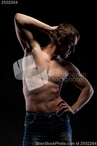 Image of Muscular naked man on black