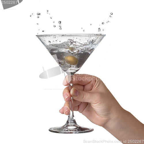 Image of Martini with splash and olive in womans hand isolated on white