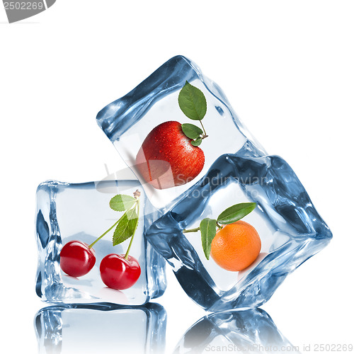 Image of fruits in ice cubes isolated on white