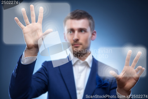 Image of business man pressing touchscreen button