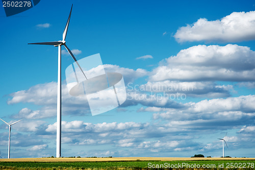 Image of Wind generator turbines on summer landscape