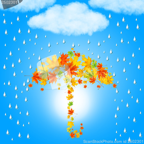 Image of umbrella from autumn leaves under cloud and rain