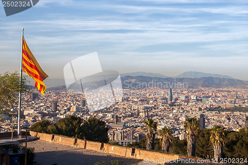 Image of Aerial view of Barcelona city with flag of Spain