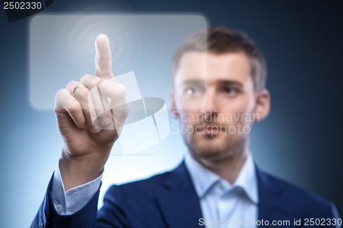 Image of business man pressing touchscreen button