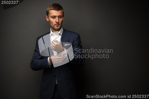 Image of handsome businessman on black