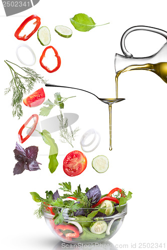 Image of Falling vegetables for salad and oil isolated