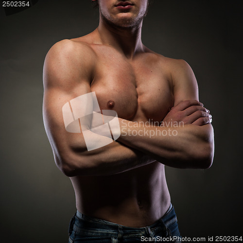 Image of Muscular naked man on black