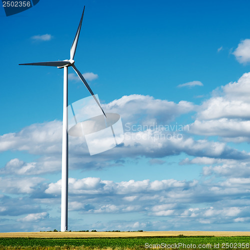 Image of Wind generator turbine on summer landscape