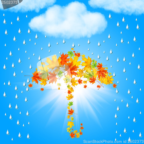 Image of umbrella from autumn leaves under cloud and rain