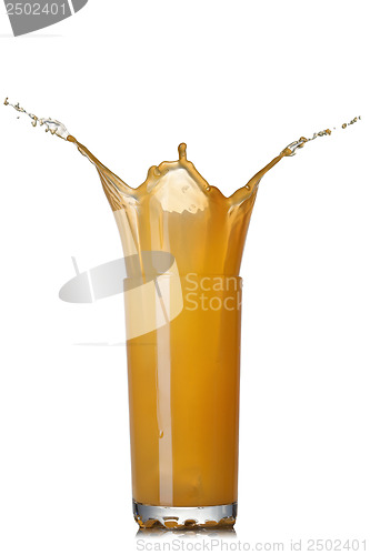 Image of Splash of orange juice in glass isolated on white