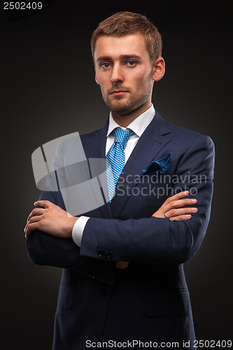 Image of portrait of handsome businessman on black