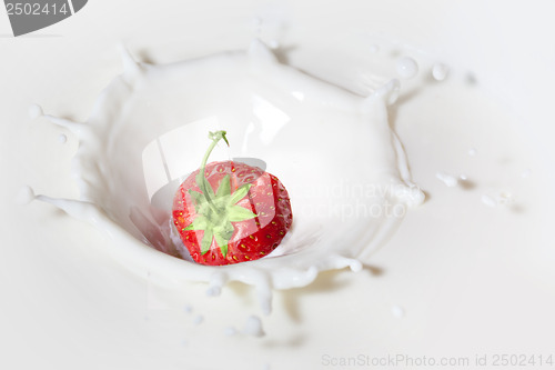 Image of Strawberry dropped into milk with splash