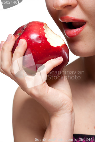 Image of Young woman biting red apple isolated on white