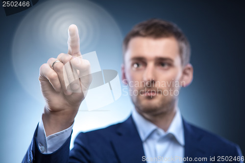 Image of business man pressing touchscreen button