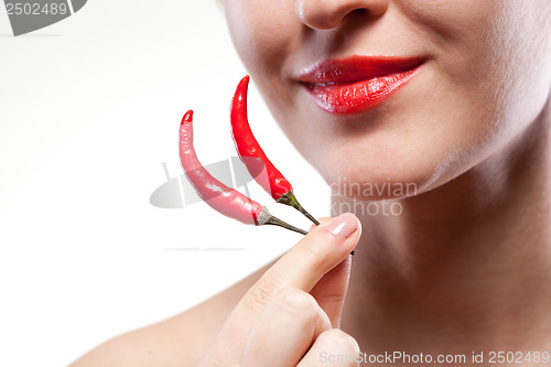 Image of Young woman with chili pepper isolated on white