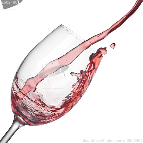 Image of Splash of rose wine in wineglass on white