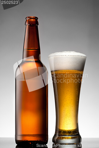 Image of Beer in glass and bottle on white