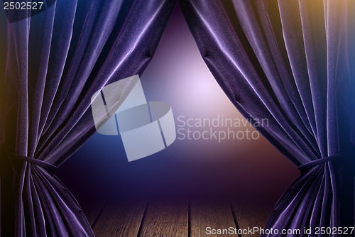 Image of violet curtains in theater with dramatic light