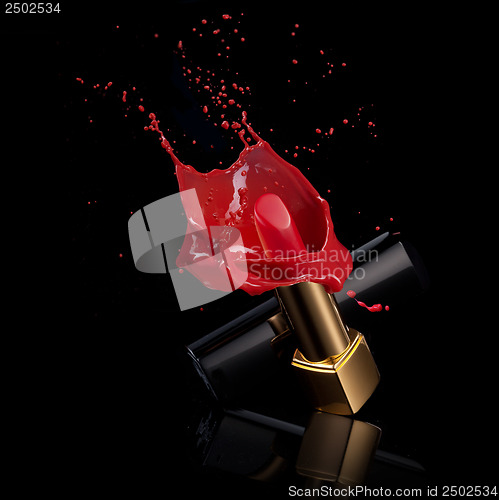 Image of red lipstick with splash of paint isolated on black