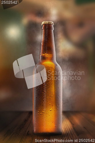 Image of Cold beer bottle with drops, frost and vapour
