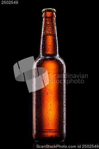 Image of Beer bottle with water drops isolated on black