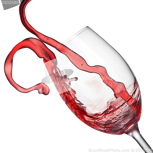 Image of Splash of red wine in wineglass isolated on white