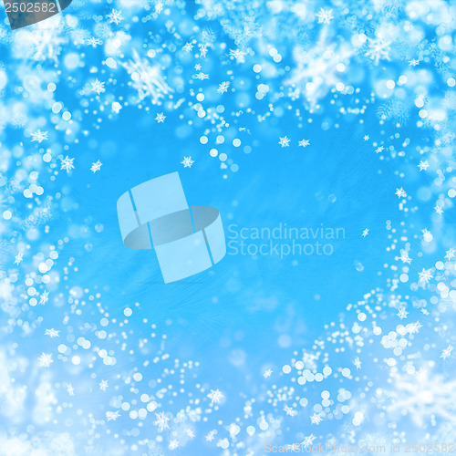 Image of blue winter background with heart and snowflakes