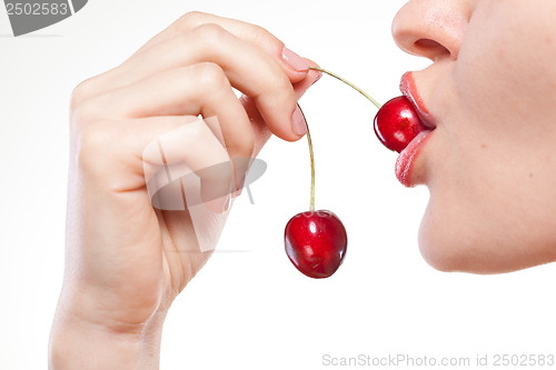 Image of Young woman with cherry isolated on white