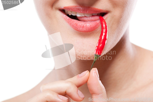 Image of Young woman with chili pepper isolated on white