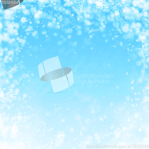 Image of blue winter background with snow and snowflakes