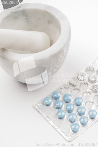 Image of Blue drugs (tablets) and marble mortar