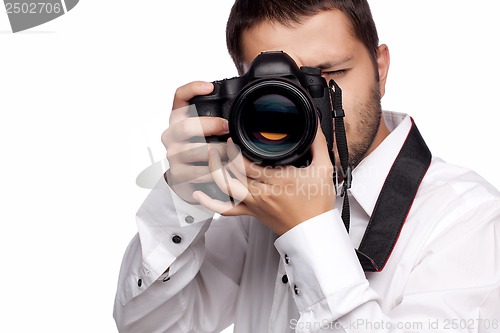 Image of Young man taking photo with professional camera