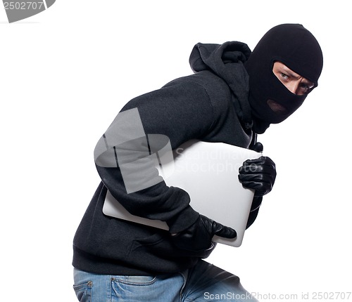 Image of Thief stealing a laptop computer