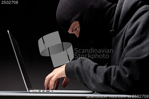 Image of Computer hacker in a balaclava