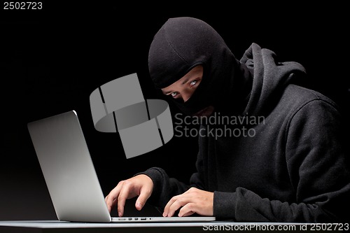 Image of Computer hacker in a balaclava