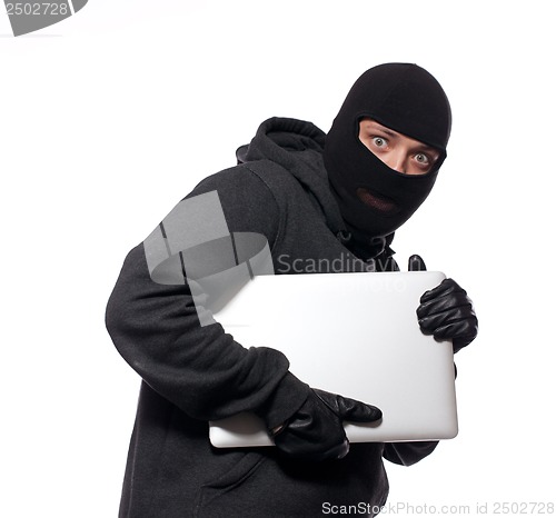 Image of Thief stealing a laptop computer