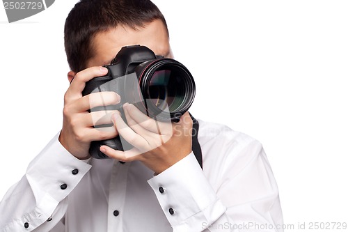 Image of Young man taking photo with professional camera