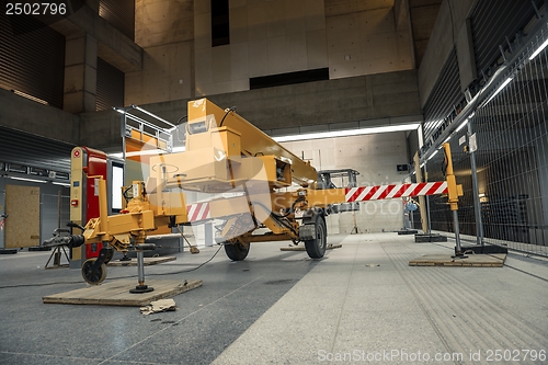 Image of Yellow mobile industrial crane in a building