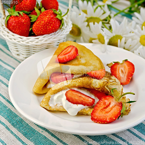 Image of Pancakes with strawberries on a napkin